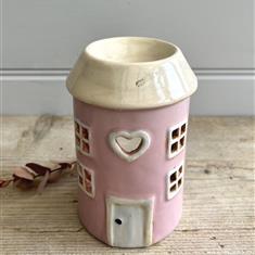 Pink pottery house which is also a wax melt burner